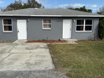 Charming one-story duplex home with a well-maintained yard and convenient individual entrances at 3715 1/2 Avenue J Nw, Winter Haven, FL 33881