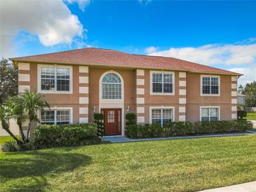 Two-story house with a brown facade, red roof, and manicured lawn at 4610 Salamander St, St Cloud, FL 34772