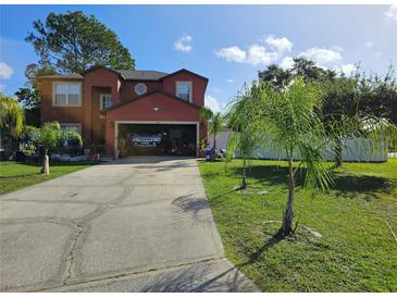 Charming two-story home with a spacious driveway, attached garage, and lush green lawn at 438 Spike Ct, Kissimmee, FL 34759
