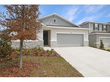 Charming home featuring stone accents, manicured landscaping, and a two-car garage at 1753 Carnelian St, Deland, FL 32720