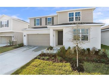 Charming two-story home with a well-maintained lawn and neutral color scheme at 5418 Catmint Dr, Lake Hamilton, FL 33851