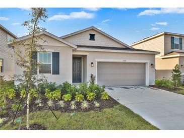 Charming single-story home with a two-car garage, manicured lawn, and inviting front door at 5422 Catmint Dr, Lake Hamilton, FL 33851