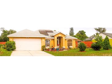 Charming single-story home with well-maintained landscaping and solar panels, enhancing curb appeal at 1053 Hemingway Dr, Deltona, FL 32725