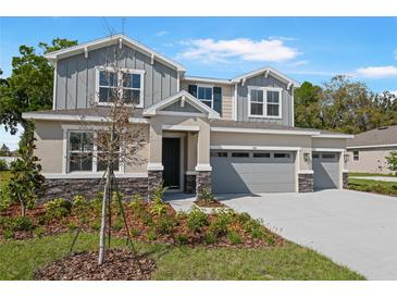 Charming two-story home with a well-manicured lawn and a three car garage at 3709 Deer Ridge Dr, Mount Dora, FL 32757
