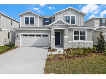 Charming two-story home with a two-car garage and well-maintained landscaping at 1455 August Gray Dr, Kissimmee, FL 34744
