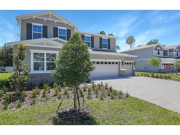 Beautiful two-story home featuring stone accents, a three-car garage and landscaped front yard at 3724 Deer Ridge Dr, Mount Dora, FL 32757