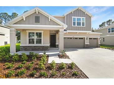 Charming two-story home with a two-car garage and a well-maintained front yard landscape at 3732 Deer Ridge Dr, Mount Dora, FL 32757