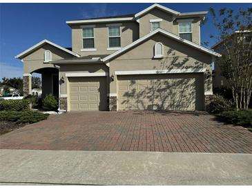 Charming two-story home featuring a spacious driveway and a two-car garage in a well-maintained neighborhood at 1222 Castlevecchio Loop, Orlando, FL 32825