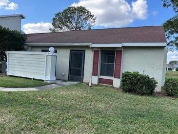 Charming single-story home with a well-maintained lawn and cozy curb appeal at 98 Pine Island Cir, Kissimmee, FL 34743