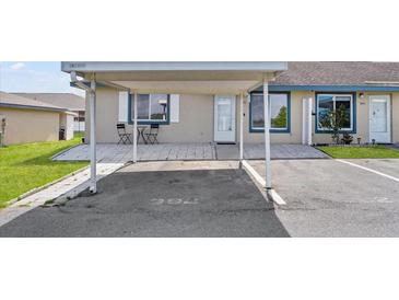 Charming condo featuring an outdoor patio and carport with designated parking space at 392 Winter Ridge Blvd # 105, Winter Haven, FL 33881