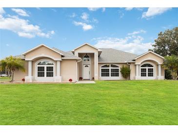 Charming single-story home with well-manicured lawn and beautiful architectural details at 1960 Jan Lan Blvd, St Cloud, FL 34772