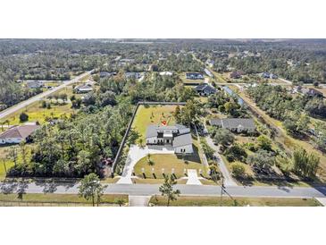 Aerial view of a single-Gathering home with a large backyard and surrounding landscape at 18802 Robertson St, Orlando, FL 32833