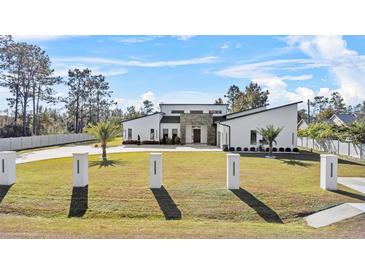 Modern home with stone accents and landscaped yard at 18802 Robertson St, Orlando, FL 32833