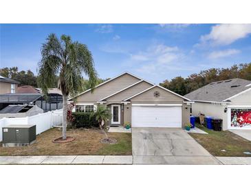 Charming single-Gathering home featuring a well-maintained lawn, two-car garage, and inviting curb appeal at 2372 Topaz Trl, Kissimmee, FL 34743