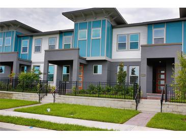 Modern townhome boasts colorful design, professional landscaping, and inviting entrance at 6078 Bimini Twist Loop, Orlando, FL 32819