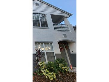 Two-story house exterior with festive wreath, landscaping, and balcony at 4320 S Kirkman Rd # 1513, Orlando, FL 32811