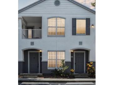 Charming two-story condo with a balcony, large windows, and well-manicured landscaping at 4368 S Kirkman Rd # 201, Orlando, FL 32811