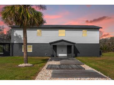 Two story home featuring modern siding and a landscaped walkway leading to the front door at 5155 Haywood Ruffin Rd, Saint Cloud, FL 34771