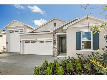 Two-story house with a two-car garage and landscaping at 1746 Carnelian St, Deland, FL 32720