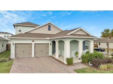 Charming one-story home with a two-car garage, inviting front porch, and nicely landscaped front yard at 19041 Blueleaf St, Orlando, FL 32827