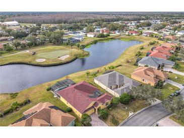 Aerial view of a house community with golf course and lake at 304 Sorrento Road, Poinciana, FL 34759