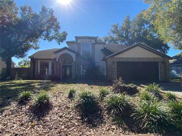 Two-story house with a two-car garage and landscaped lawn at 515 Bentley St, Oviedo, FL 32765