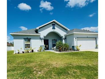 Single-story home with a two-car garage and landscaped lawn at 932 Albertville Ct, Kissimmee, FL 34759