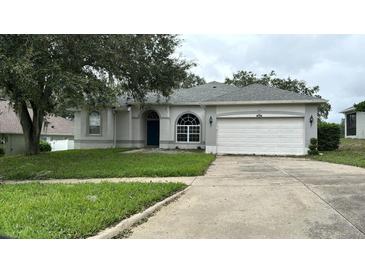 One-story home with attached garage, and well-maintained lawn at 2684 Clearview St, Clermont, FL 34711