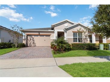 Single-story home with a two-car garage and landscaped yard at 2756 Greenlands St, St Cloud, FL 34772