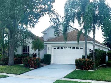 Single-story home with a white garage door and landscaping at 2835 Crane Trace Cir, Orlando, FL 32837