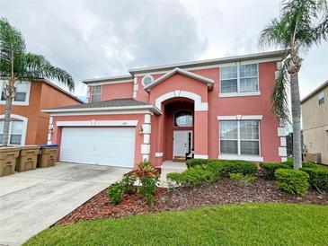 Two-story house with a large garage and well-manicured landscaping at 160 Hideaway Beach Ln, Kissimmee, FL 34746