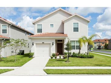 Two-story house with a two-car garage, and a well-maintained lawn at 2950 Buccaneer Palm Rd, Kissimmee, FL 34747