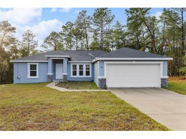 Newly built home with a two-car garage and landscaped yard at 832 Marion Oaks Mnr, Ocala, FL 34473