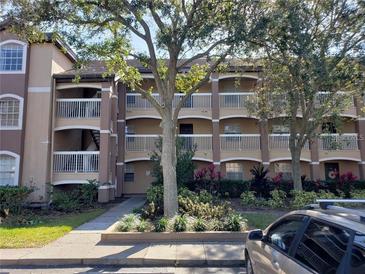 Condo building exterior with landscaping and parking at 13803 Fairway Island Dr # S, Orlando, FL 32837