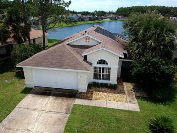 Charming home with a well-maintained lawn and a beautiful lake view in the backyard at 2993 Stillwater Dr, Kissimmee, FL 34743