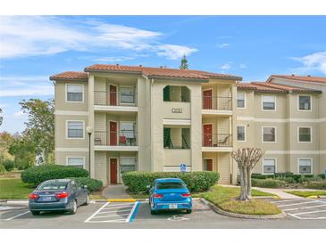 Two-story condo building with ample parking and landscaping at 3036 Parkway Blvd # 104, Kissimmee, FL 34747