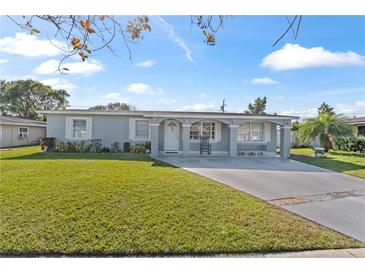 Ranch-style home with a well-maintained lawn and driveway at 7804 Acadian Dr, Orlando, FL 32822