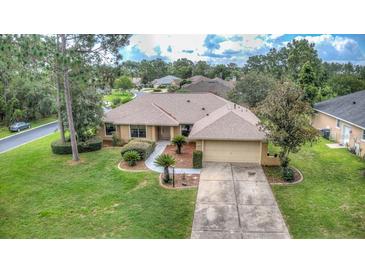 Single-story home with a two-car garage and spacious yard at 26 Lake Diamond Ave, Ocala, FL 34472