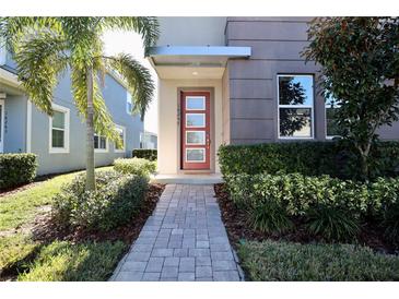 Modern home exterior with red door and landscaped walkway at 16257 Prairie School Dr, Winter Garden, FL 34787