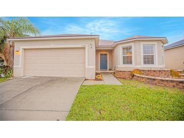 Single-story home with a two-car garage and landscaped lawn at 3643 Julius Estates Blvd, Winter Haven, FL 33881