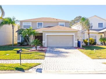 Two-story house with a paved driveway and landscaping at 4608 Cumbrian Lakes Dr, Kissimmee, FL 34746