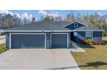 House exterior showcasing a two-car garage and well-manicured lawn at 534 Bristol Cir, Kissimmee, FL 34758