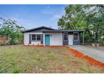 Newly renovated home with a teal door and modern exterior at 1414 Vonderay Rd, Orlando, FL 32825