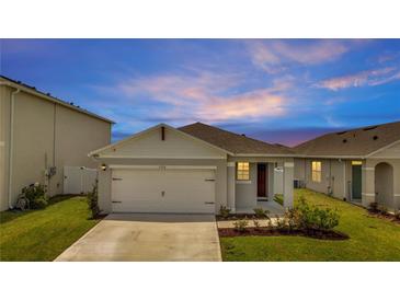 One-story home with a two-car garage and landscaped front yard at 1516 Quinta Rd, Kissimmee, FL 34744