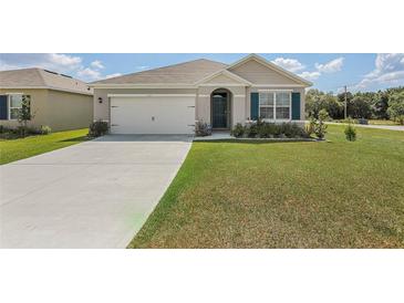 One-story house with a two-car garage and landscaped lawn at 362 Alexzander Way, Winter Haven, FL 33881