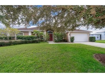 Single-story home with a large yard and mature trees at 11322 Bronson Rd, Clermont, FL 34711