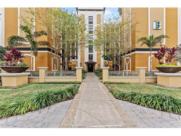 Resort-style building exterior with palm trees and walkway at 12544 Floridays Resort Dr, Orlando, FL 32821