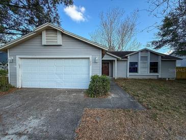 Charming one-story home featuring a two-car garage and well-maintained lawn at 1823 Natchez Trace Blvd, Orlando, FL 32818