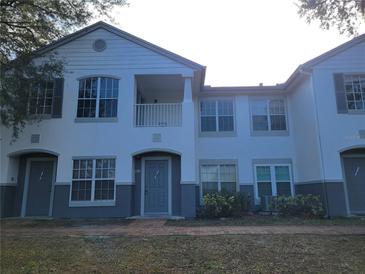 Two-story condo building with gray and white exterior at 4332 S Kirkman Rd # 1013, Orlando, FL 32811