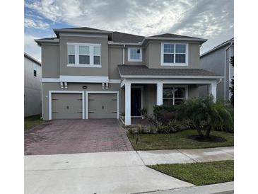 Two-story house with a two-car garage and landscaped front yard at 14429 Wabasso Loop, Winter Garden, FL 34787